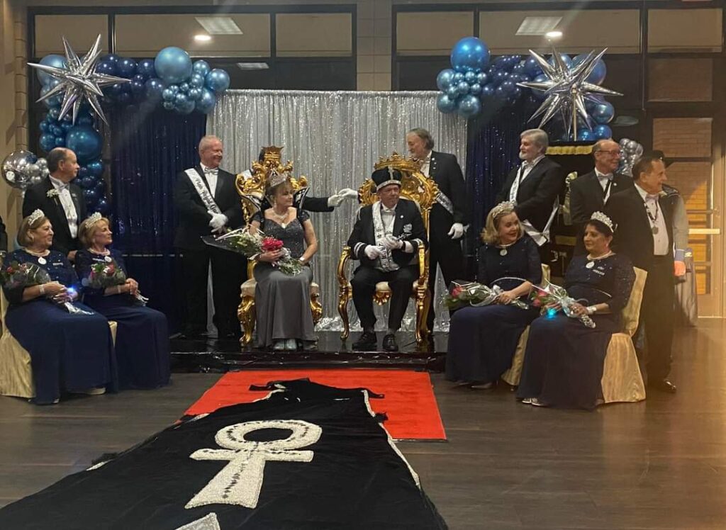 people posing for a royal themed coronation.